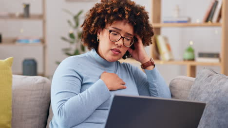 laptop, bad news and loss with a woman on a sofa