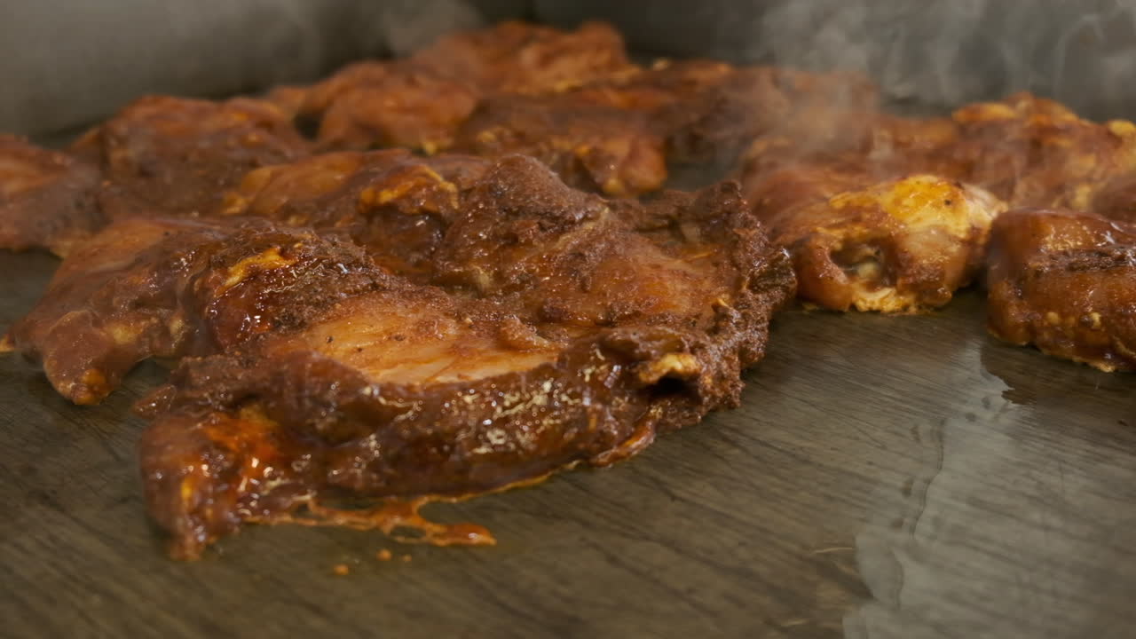 Chicken cooking on a commercial grill, high speed