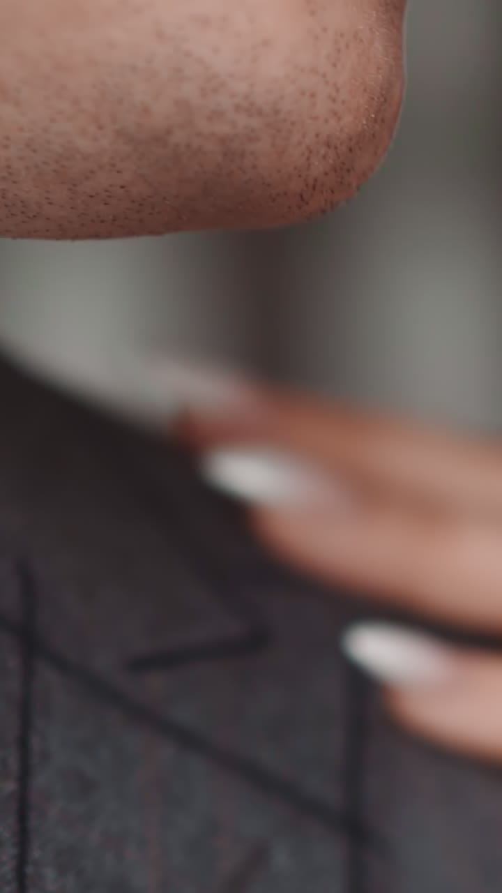 Woman touches man in checkered jacket shoulder and guy turns head back closeup slow motion. Lovely young couple enjoys romantic date. Passion relationship