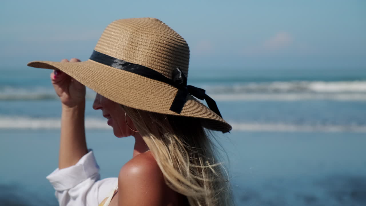 Woman in straw hat on the beach