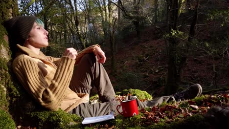 traveling woman smoking in forest at sunset