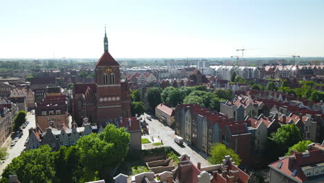 aerial - flying over gdansk old town buildings - church of sts