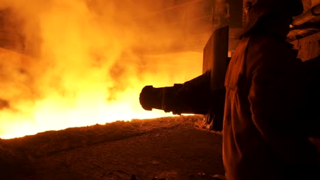 steel mill worker observing hot metal process