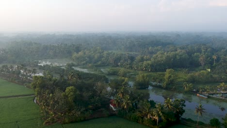 Sunrise-in-a-Asian-paddy-field-village,Sun-beam-reflection-,River,Aerial-Shot,irrigation,Mist,Mangroves,Water,Sky