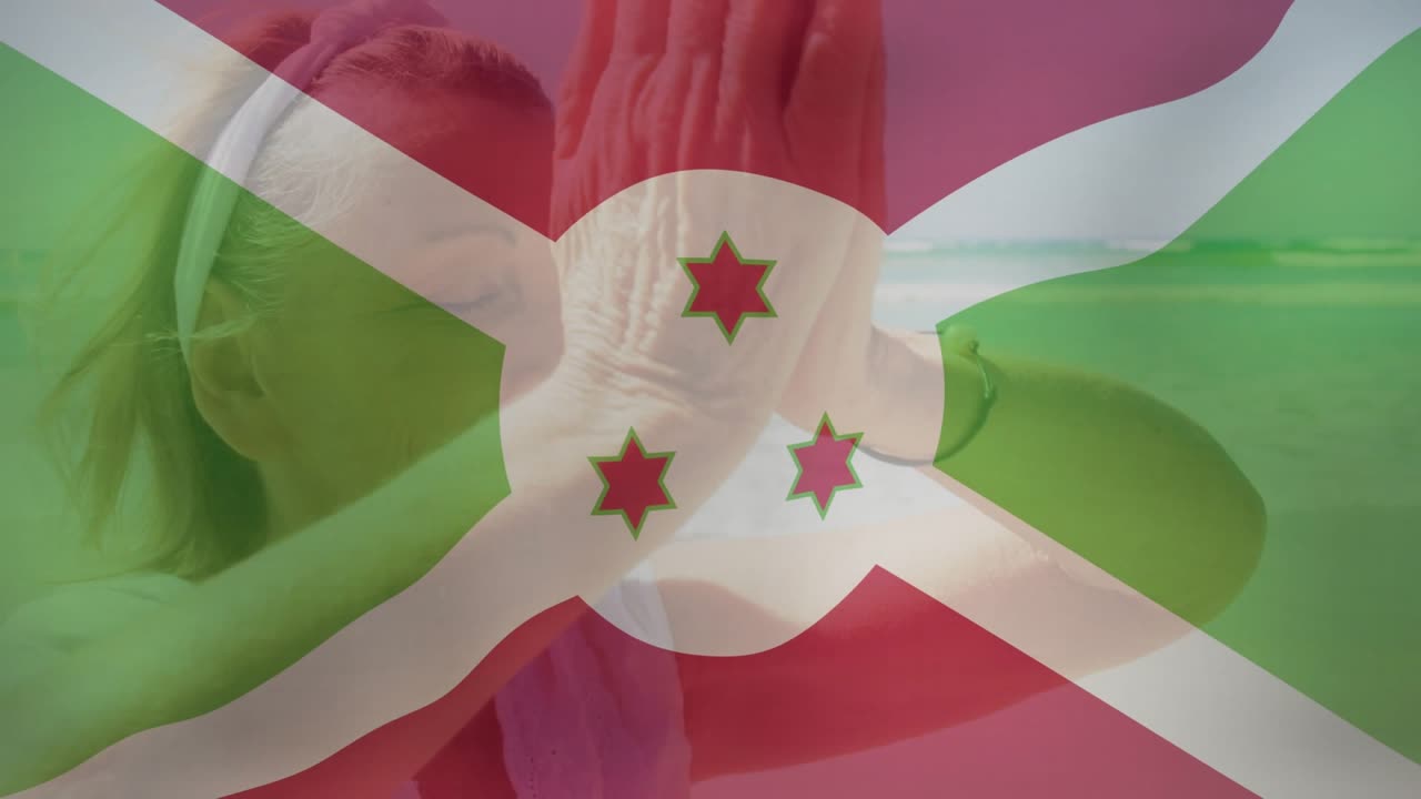 Woman starting palms-chest pose and lifting through flag overlay at beach for health