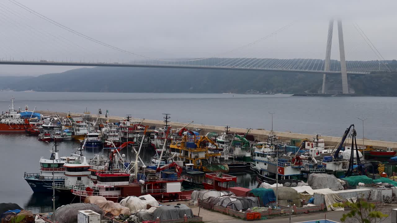 Yavuz Sultan Selim Bridge over Bosphorus Strait Istanbul with fishing boats docked in foreground