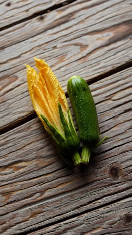 fresh zucchini and zucchini flower on wood