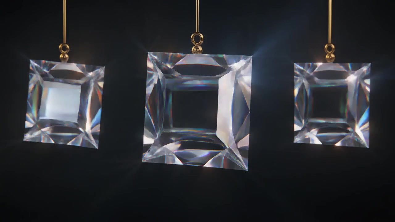 Three Hanging Crystal Prisms Rotating Against a Dark Background
