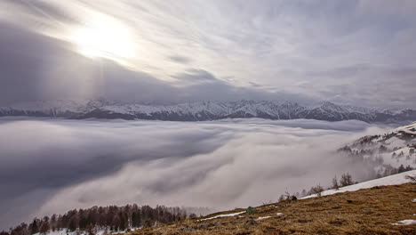 long exposure time lapse of low-lying fog in a valley below the mountains