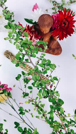 buddha statue with flowers and plants