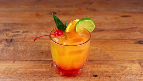 Close-up-of-a-mezcal-cocktail-being-placed-on-a-wooden-table-in-a-fast-food-restaurant