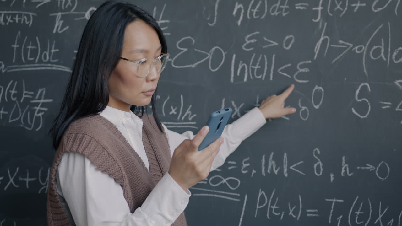 Woman explaining math equations on a chalkboard