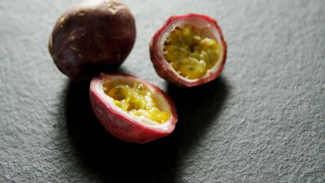 one and a half passion fruits on grey background 4k 4k