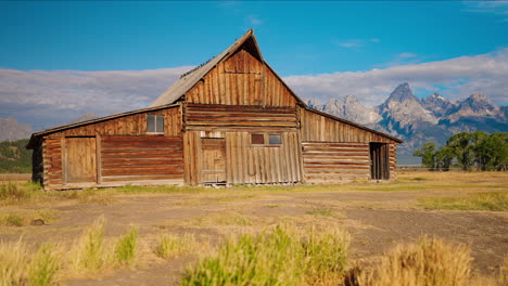 rustic wooden barn with grand teton mountains in the background