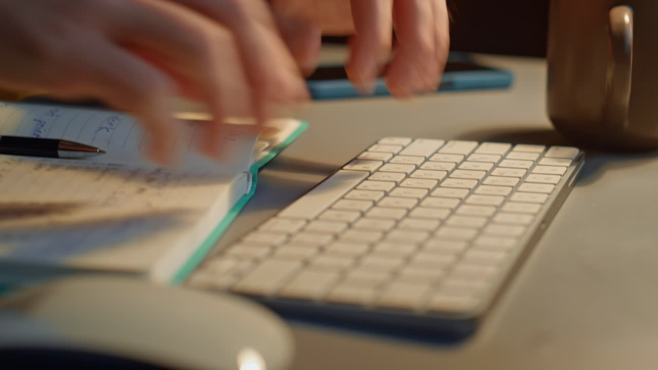 Focused man staring screen at night flat closeup. Guy hands typing keyboard