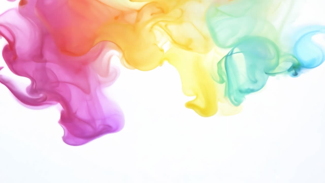 Colorful ink clouds dissolve and mix on a pure white background, creating a mesmerizing display of vibrant hues