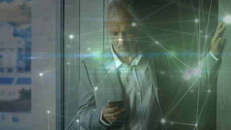 animation of network of connections caucasian businessman with smartphone in office