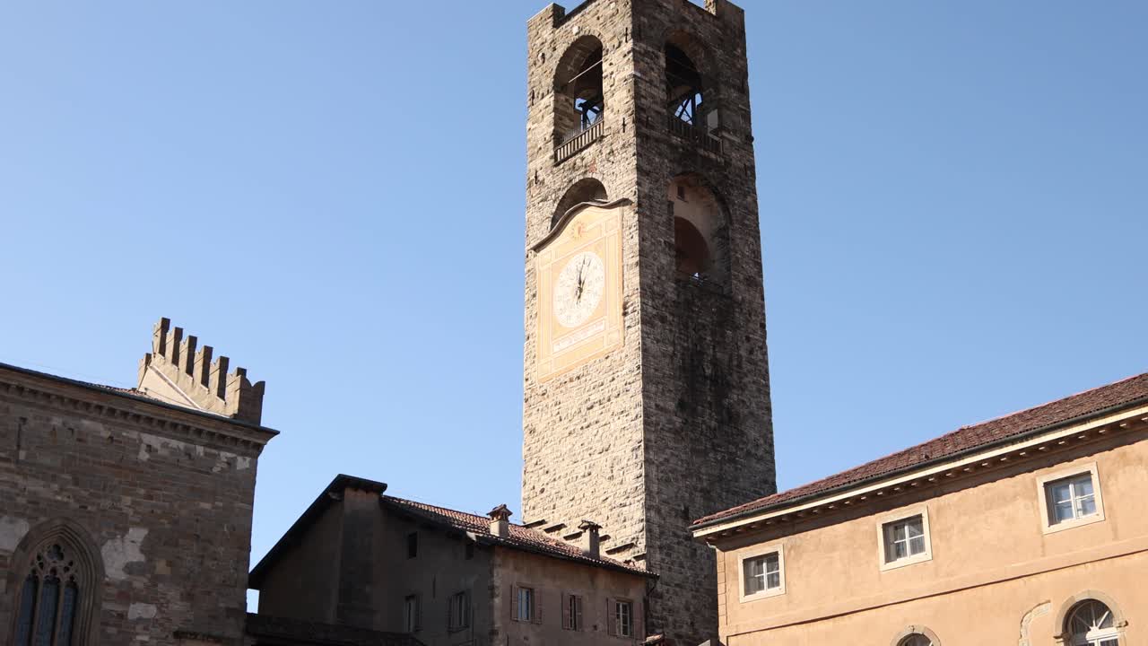 Low-angle shot of the ancient stone Civic Tower, also known as Campanone, located in the heart of Bergamo's historic Upper Town