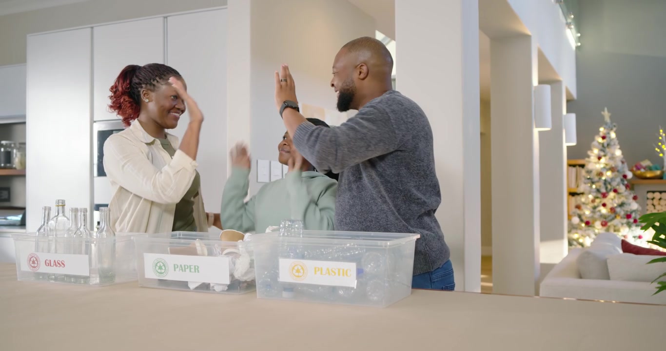 Family sorting recyclables after spotting pile, placing glass paper plastic into labeled bins