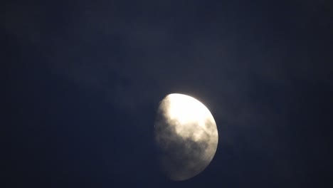 moon at night with cloud real time. 4k video moon in the black sky.  clouds passing by moon at night. night sky with cloudy weather