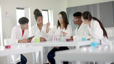 diverse students collaborate on science experiment in high school