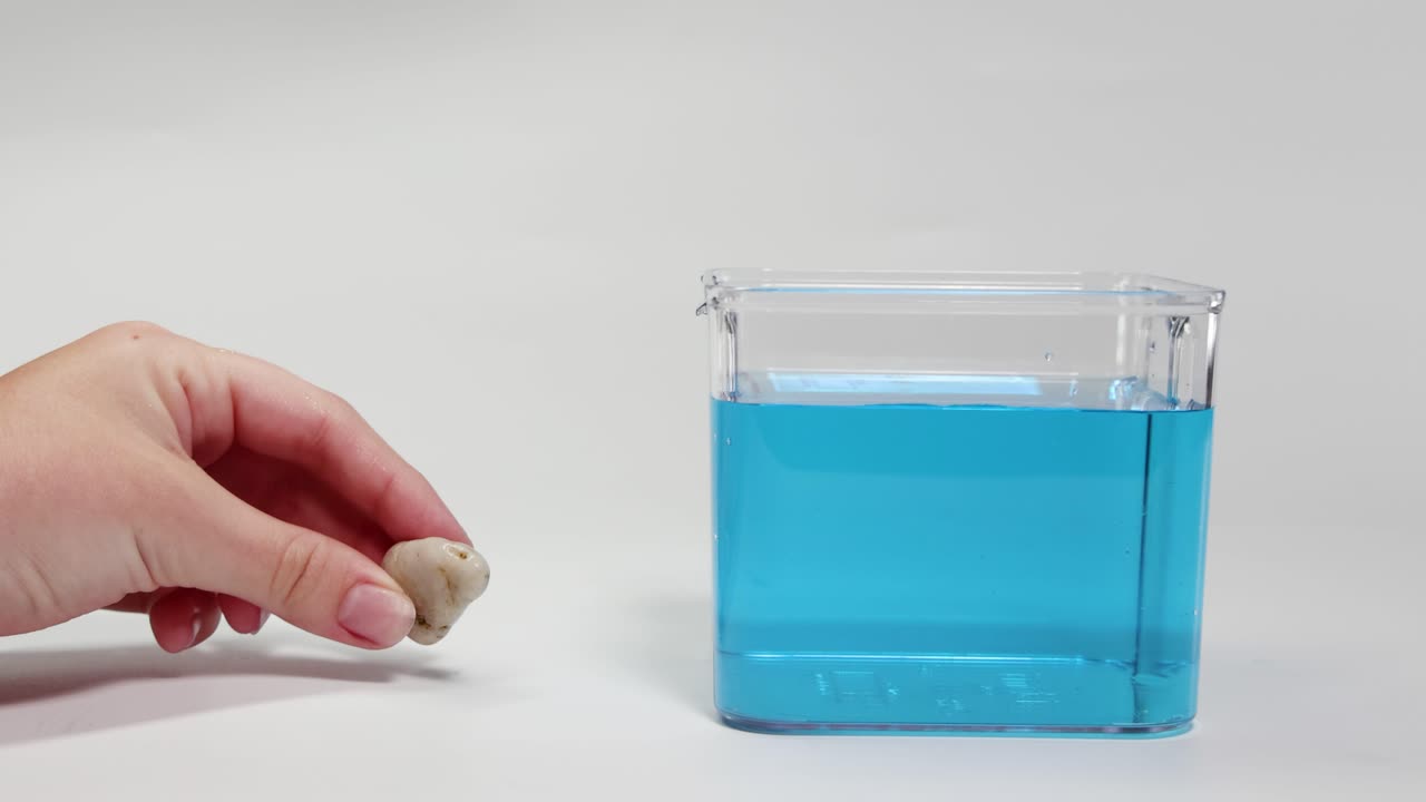Science experiment with a rock and blue liquid