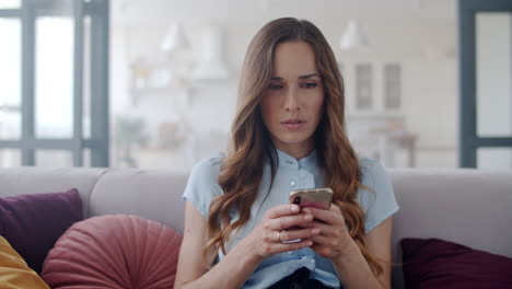 Closeup-freelancer-girl-using-smartphone-at-remote-workplace.