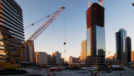 construction site of a modern skyscraper at sunrise/sunset