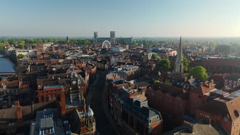 descending establishing aerial drone shot of york city at morning past clock tower uk