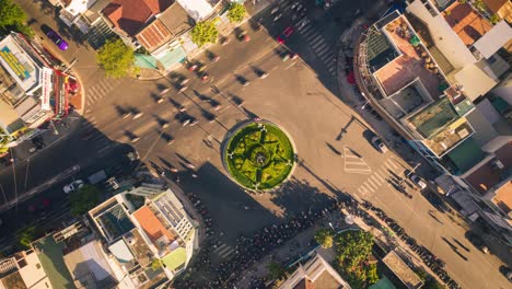 Drone-view-time-lapse-of-traffic-go-around-the-roundabout-in-Nha-Trang-city,-Vietnam