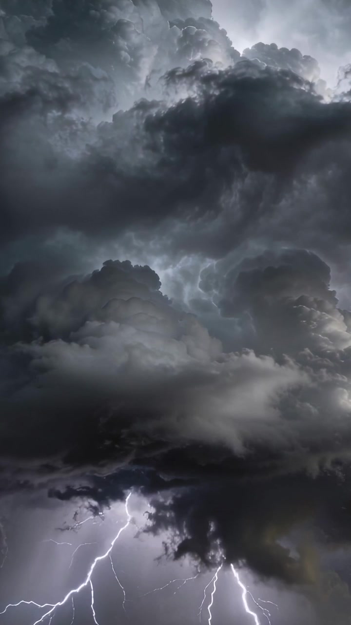 Vertical video: Flashing towering storm responding to lightning bolts in open sky, lighting base