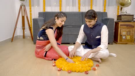 indian couple decorating home for diwali