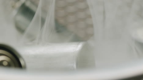 silver batteries aa and aaa in wastebasket with smoke around close-up. double-a battery is a standard size single cell cylindrical dry battery. batteries are common in portable electronic devices. environmental impacts of lithium-ion batteries concept. an aa battery is composed of a single electroch