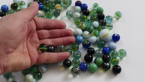 colored glass balls and marbles, close-up, glass beads in a palm,