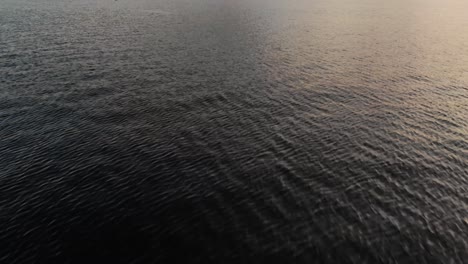 epic upward tilting aerial over lake of mt