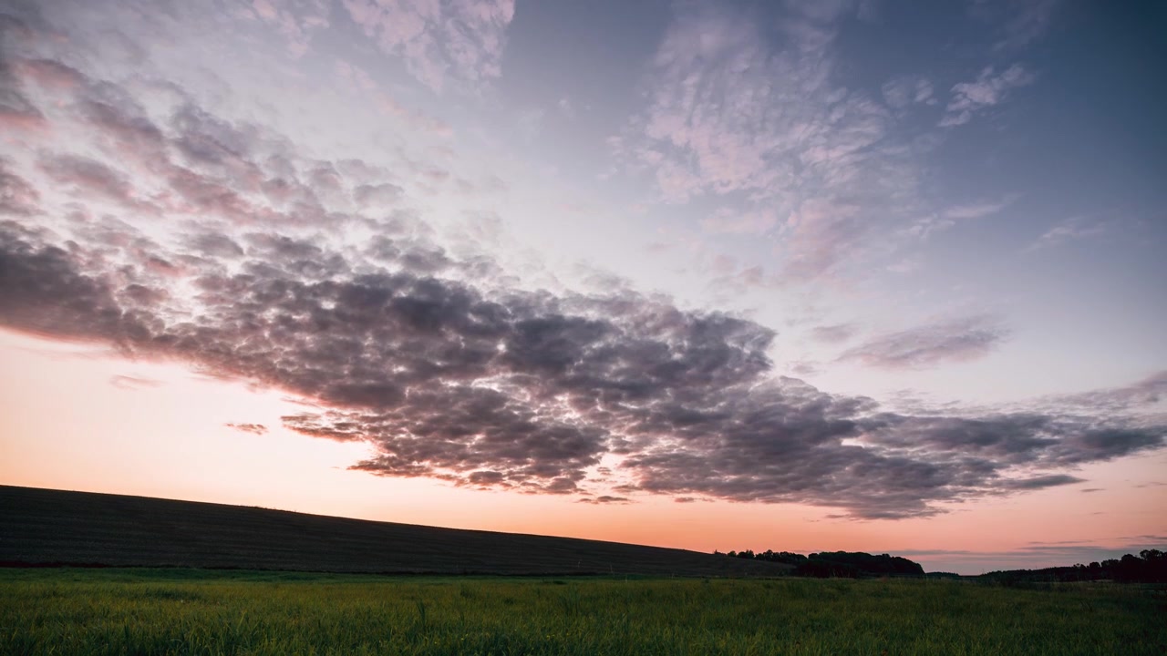Beautiful sunset time lapse video near the hill in the fields.