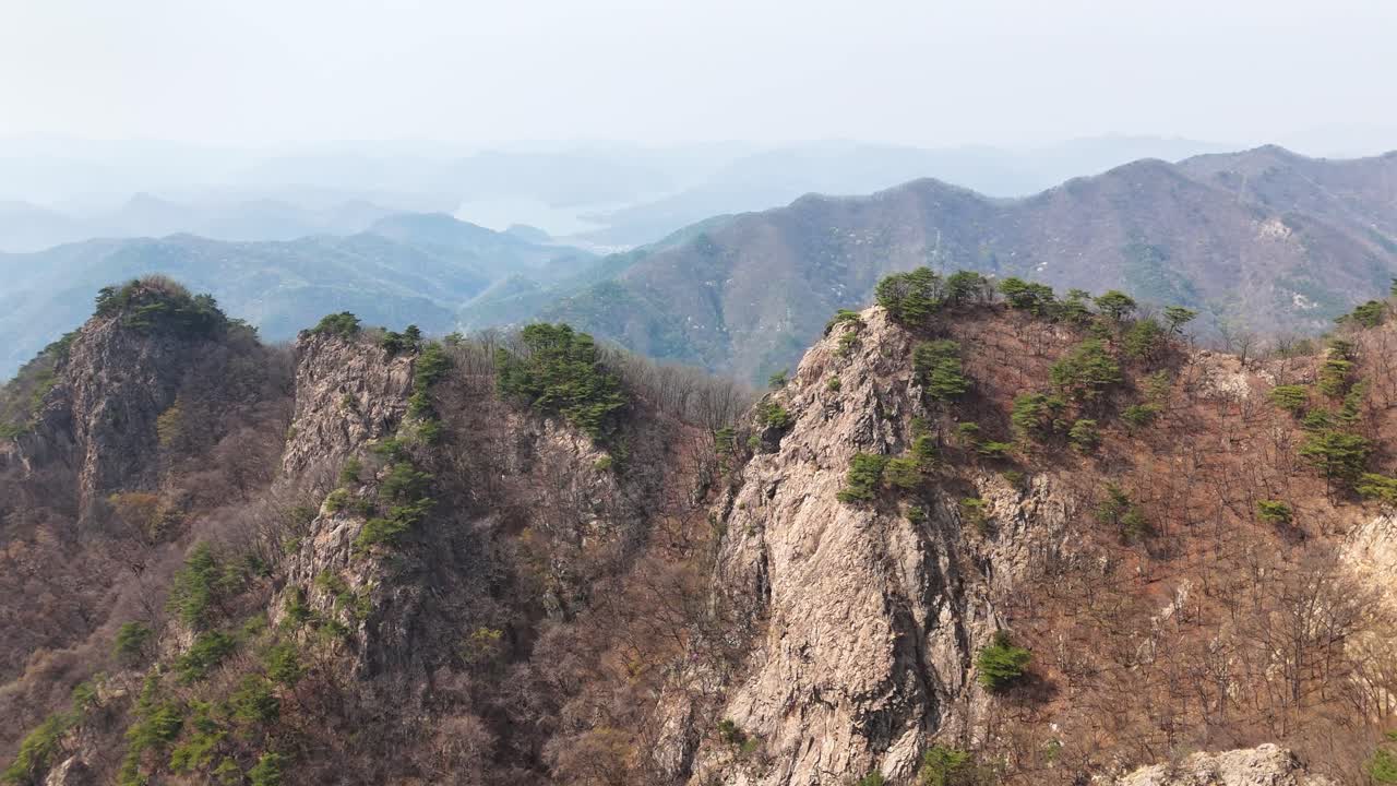 Rugged mountain peaks rising dramatically over Dongsang myeon landscape, revealing rocky geological formations highlighting South Korean wilderness terrain