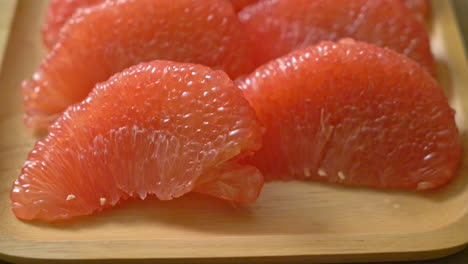 fresh red pomelo fruit or grapefruit on plate