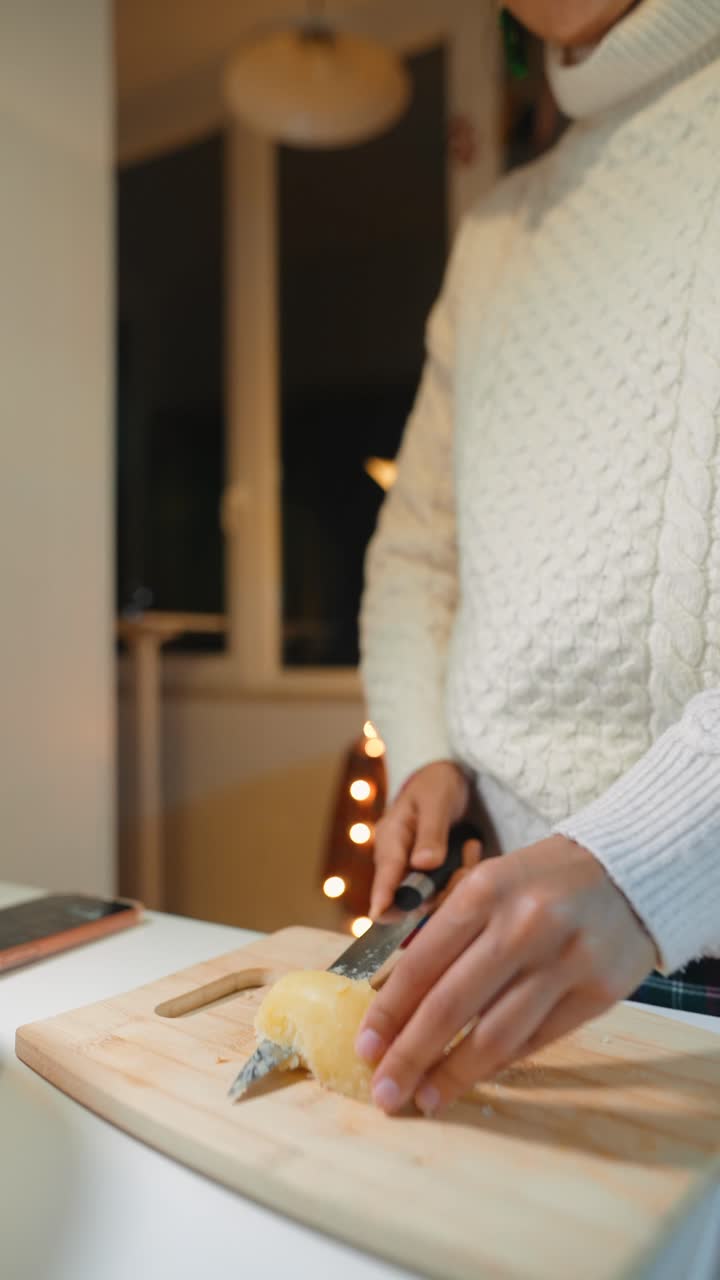 Cutting cheese on a wooden board