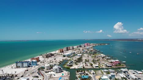 drone shot showing the businesses and condos on fort myers beach