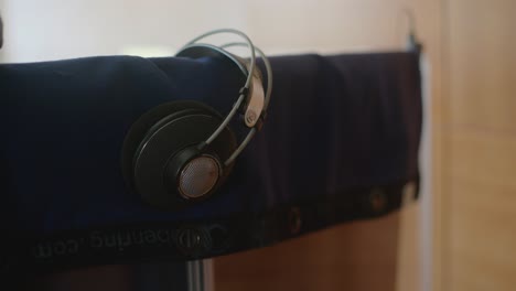 over ear studio headphones on an audio shield with a blanket in a recording studio