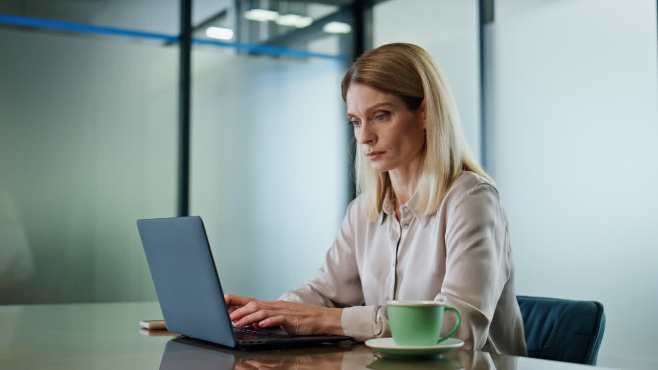 Focused businesswoman texting laptop at office closeup. Woman working computer