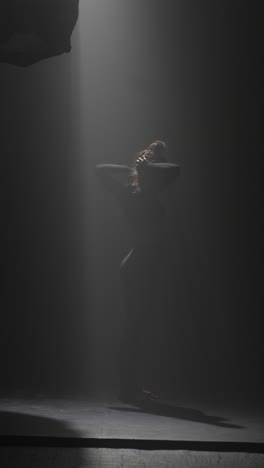 contemporary dance performance in a dark studio