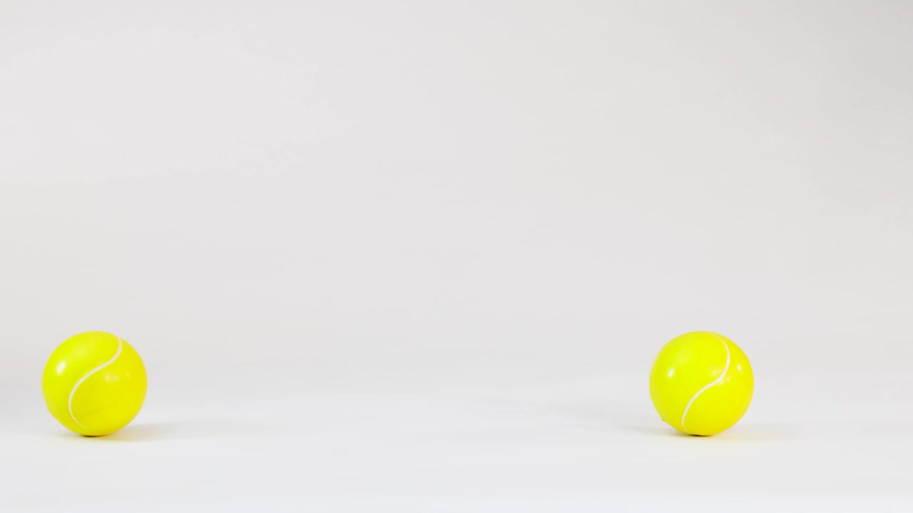 Bright Yellow Tennis Ball Rolling on a White Background