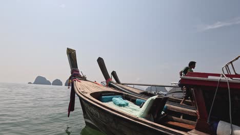 a person navigating a wooden boat on calm waters.