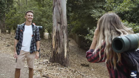 female hiker with photo camera taking pictures