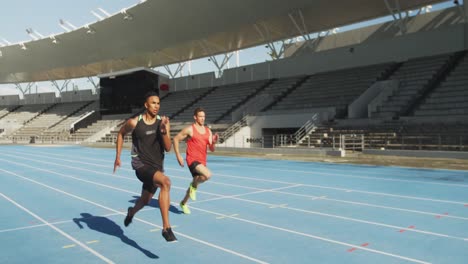 Two-athletes-running-in-stadium