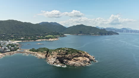 4k aerial view around crocodile-like island in shek o, hong kong