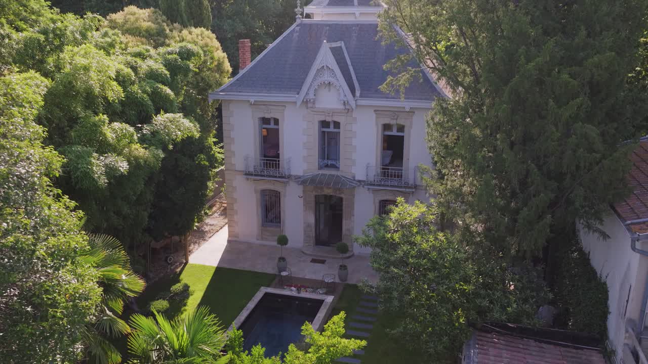 Nestled within a verdant garden, the beautiful stone cottage is accompanied by a shimmering pool, creating a tranquil oasis
