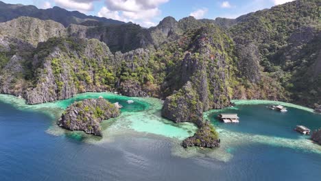 drone panoramic of rocky shore coron island with pristine waters and cliffs, exotic paradise.